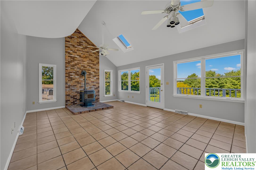630 Clearfield Road Nazareth, PA 18064 - Photo 37 of 100 Sunlight streams through multiple skylights onto the tiled floor of this vaulted living area.