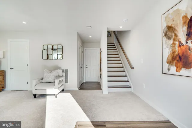 a living room with furniture and stairs