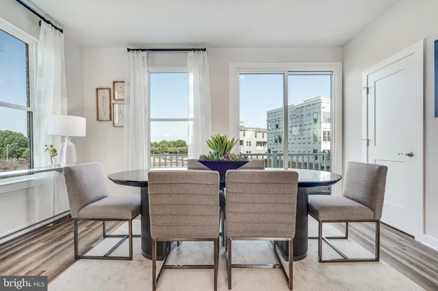 a dining room with furniture and wooden floor