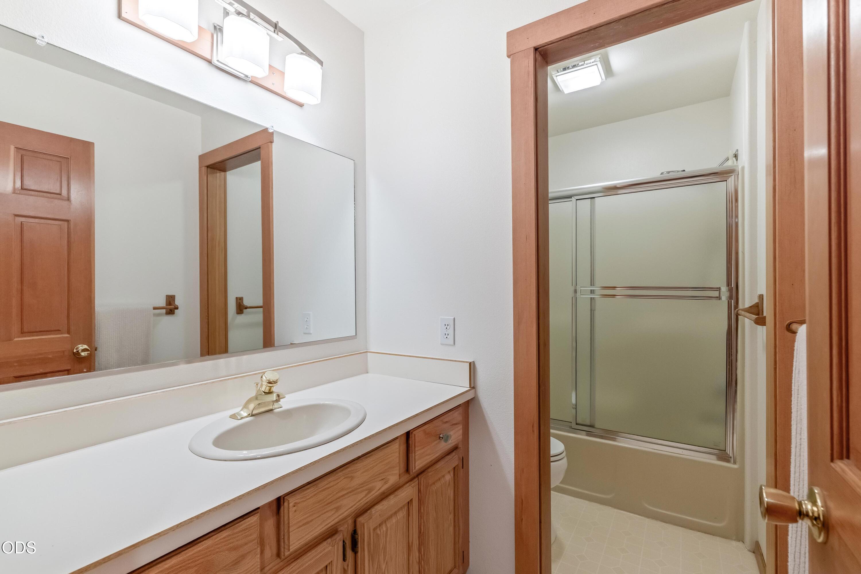 13753 South Sego Lily Road Powell Butte, OR 97753 - Photo 17 of 46 a bathroom with a sink and a mirror