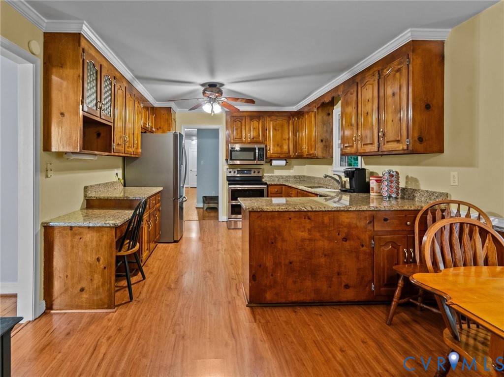 3420 State Rte 656 Powhatan, VA 23139 - Photo 10 of 37 a kitchen with stainless steel appliances granite countertop a sink a stove and a wooden floors