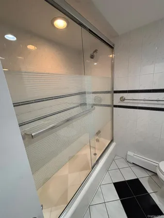 a bathroom with a shower and a toilet