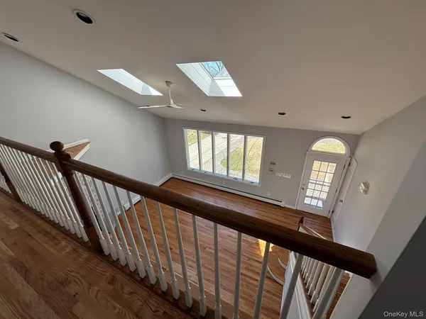 a view of entryway and hall with wooden floor