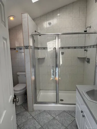 a bathroom with a shower a toilet and sink