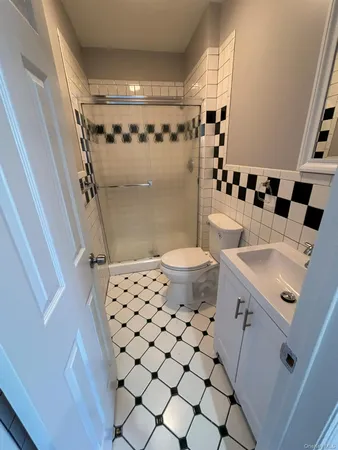a bathroom with a sink toilet and shower