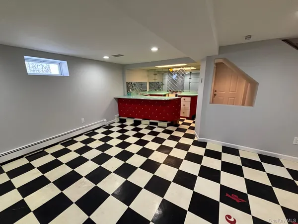 a view of a big room with a checkered floor and white checkered floor