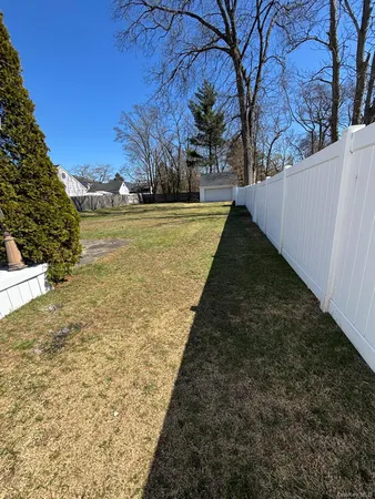 a view of yard with tree in the background
