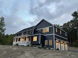 103 Nourse Road Bolton, MA 01740 - Photo 2 of 3 a front view of a house with a yard