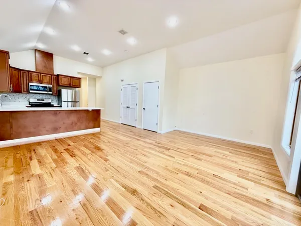 a view of kitchen and empty room