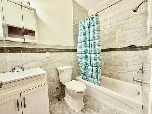 a bathroom with a toilet a sink and a bathtub