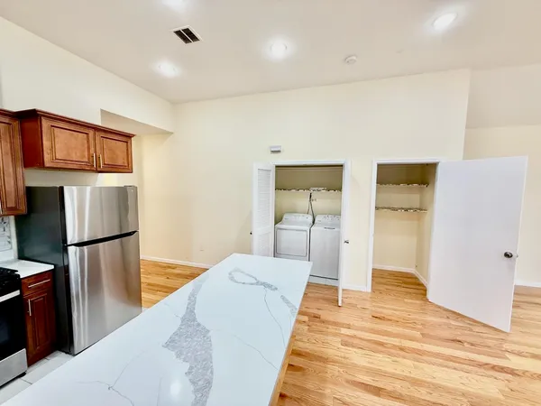 a bedroom with a bed and a view of kitchen
