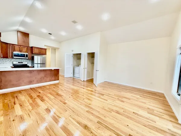 a view of a kitchen with wooden floor and a sink