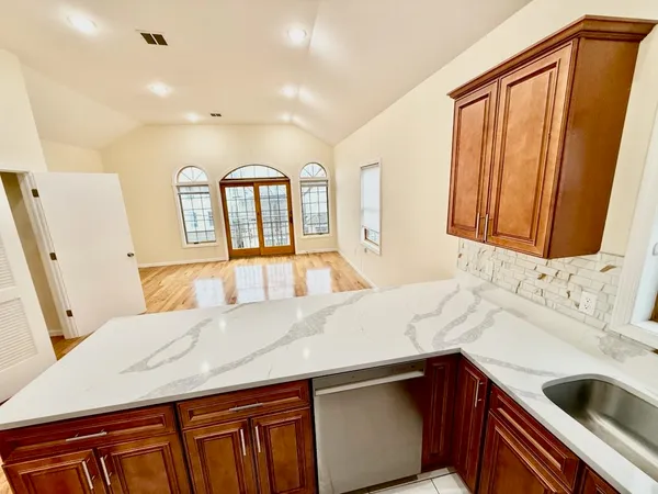 a bathroom with a granite countertop sink and a mirror