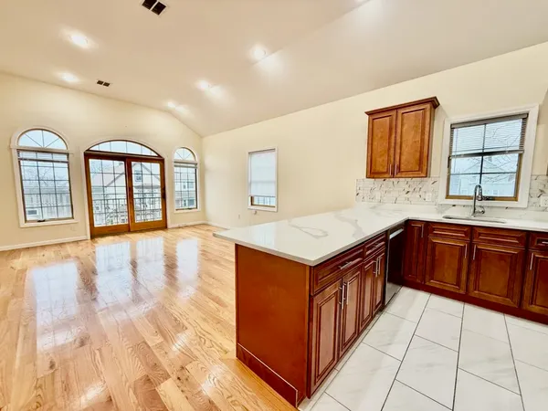 a kitchen with granite countertop a sink and a stove