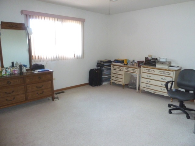 1377 Lilac Lane Addison, IL 60101 - Photo 14 of 21 a view of a workspace with furniture and a window