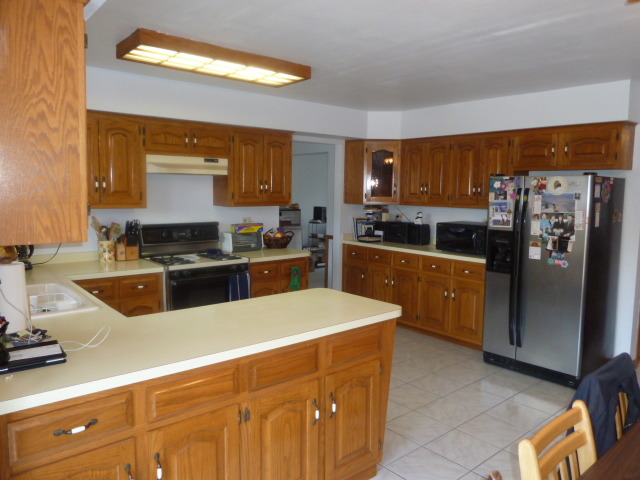 1377 Lilac Lane Addison, IL 60101 - Photo 4 of 21 a kitchen with stainless steel appliances a refrigerator sink and stove