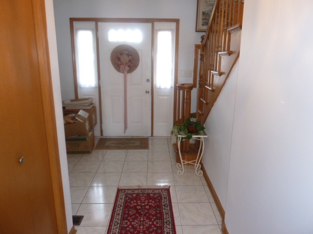 1377 Lilac Lane Addison, IL 60101 - Photo 5 of 21 a view of a hallway with wooden floor and a bathroom