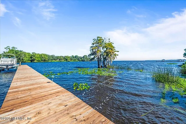an aerial view of a house with a yard and outdoor seating