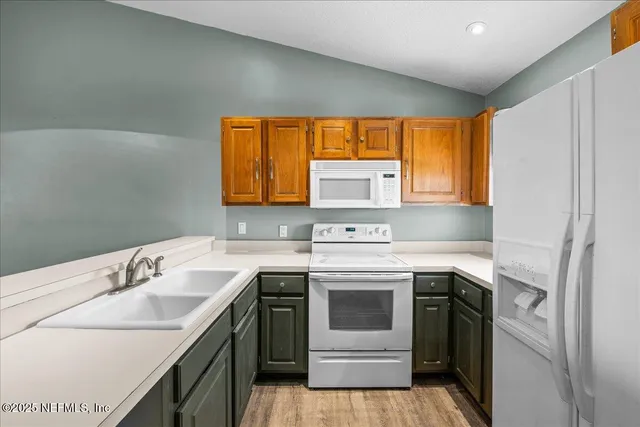 a kitchen with a sink stove and microwave
