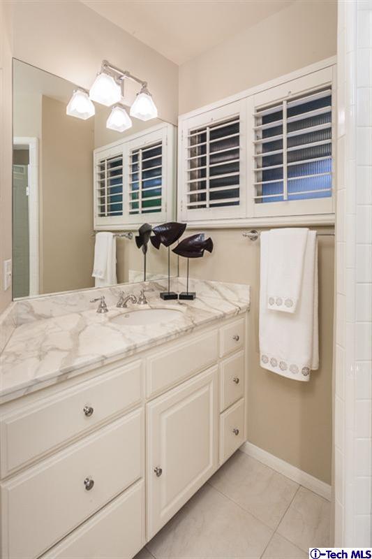 1700 Devon Road Pasadena, CA 91103 - Photo 19 of 28 a bathroom with a granite countertop sink mirror and window