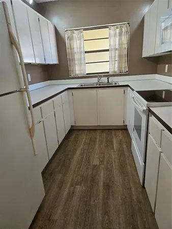 a kitchen with wooden floors and a sink