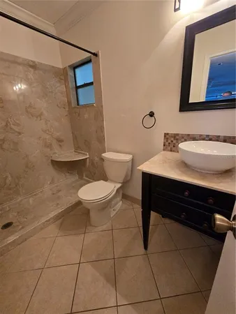 a bathroom with a sink toilet and mirror