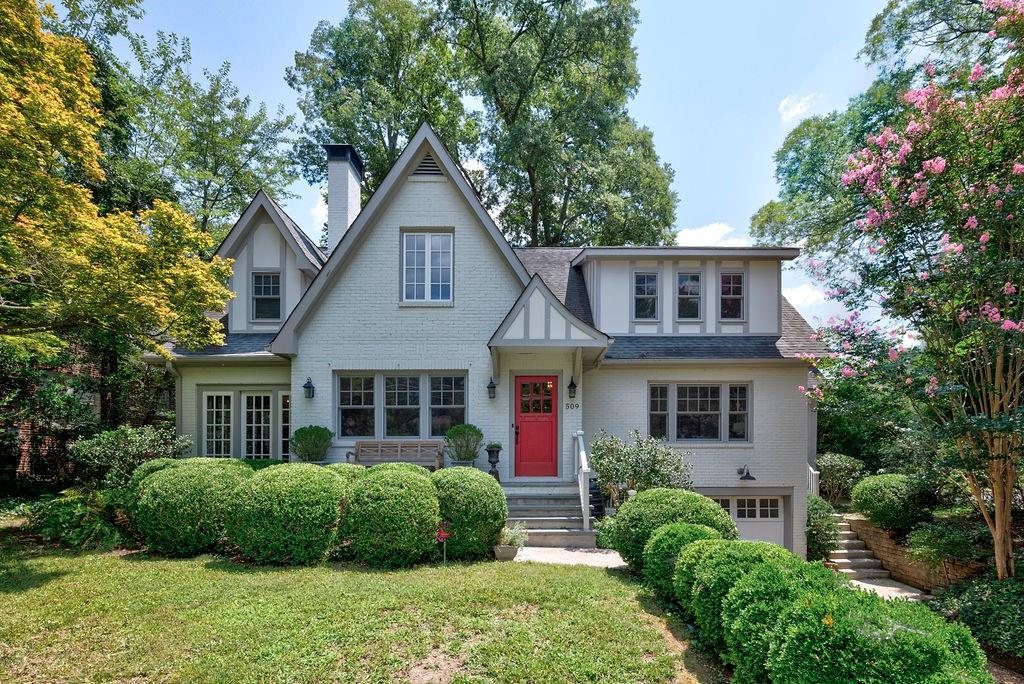 a front view of a house with a yard and plants