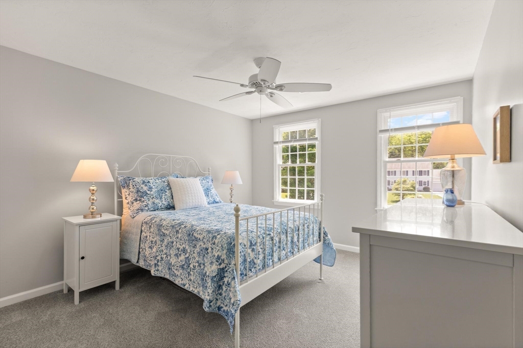 67 Bridle Path Franklin, MA 02038 - Photo 21 of 35 a bedroom with a bed chandelier and a window