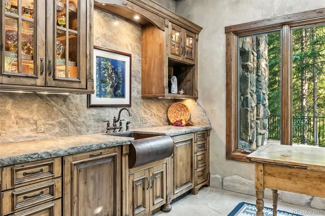 a kitchen view with a sink and garden