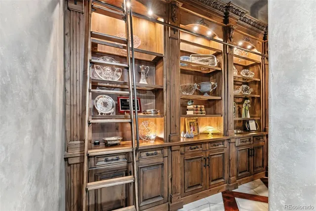 a living room with furniture a large window with kitchen view