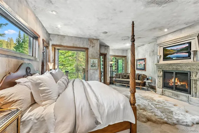 a spacious bathroom with a granite countertop tub and a large window