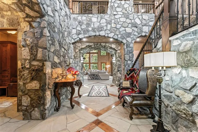 a living room with fireplace furniture and a large window