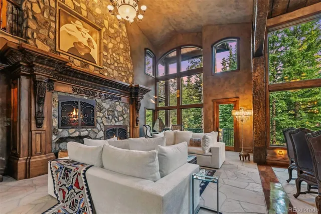 a living room with furniture fireplace and a large window