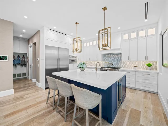 a view of a kitchen with kitchen island a large island in it