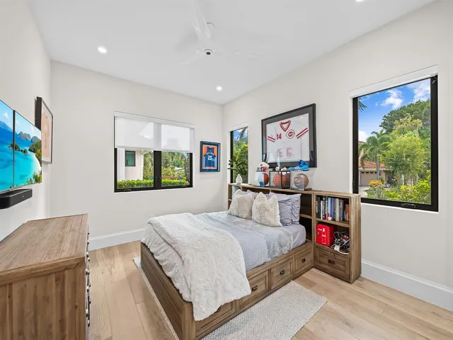 a bedroom with a bed and a view of kitchen