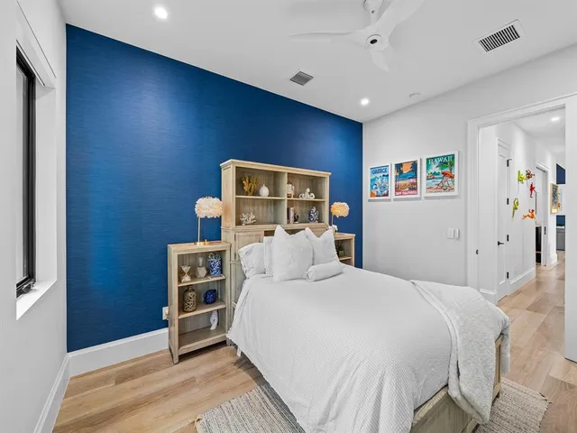 a dining room with furniture and a floor to ceiling window