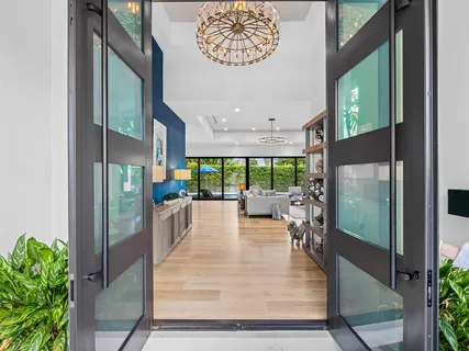 a living room with furniture and view of kitchen