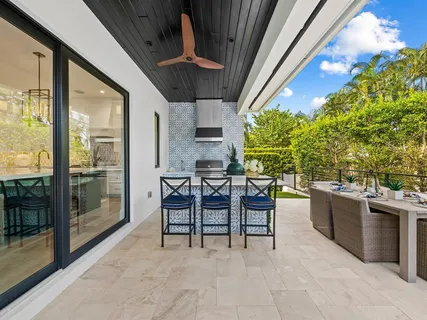 a view of a house with palm trees