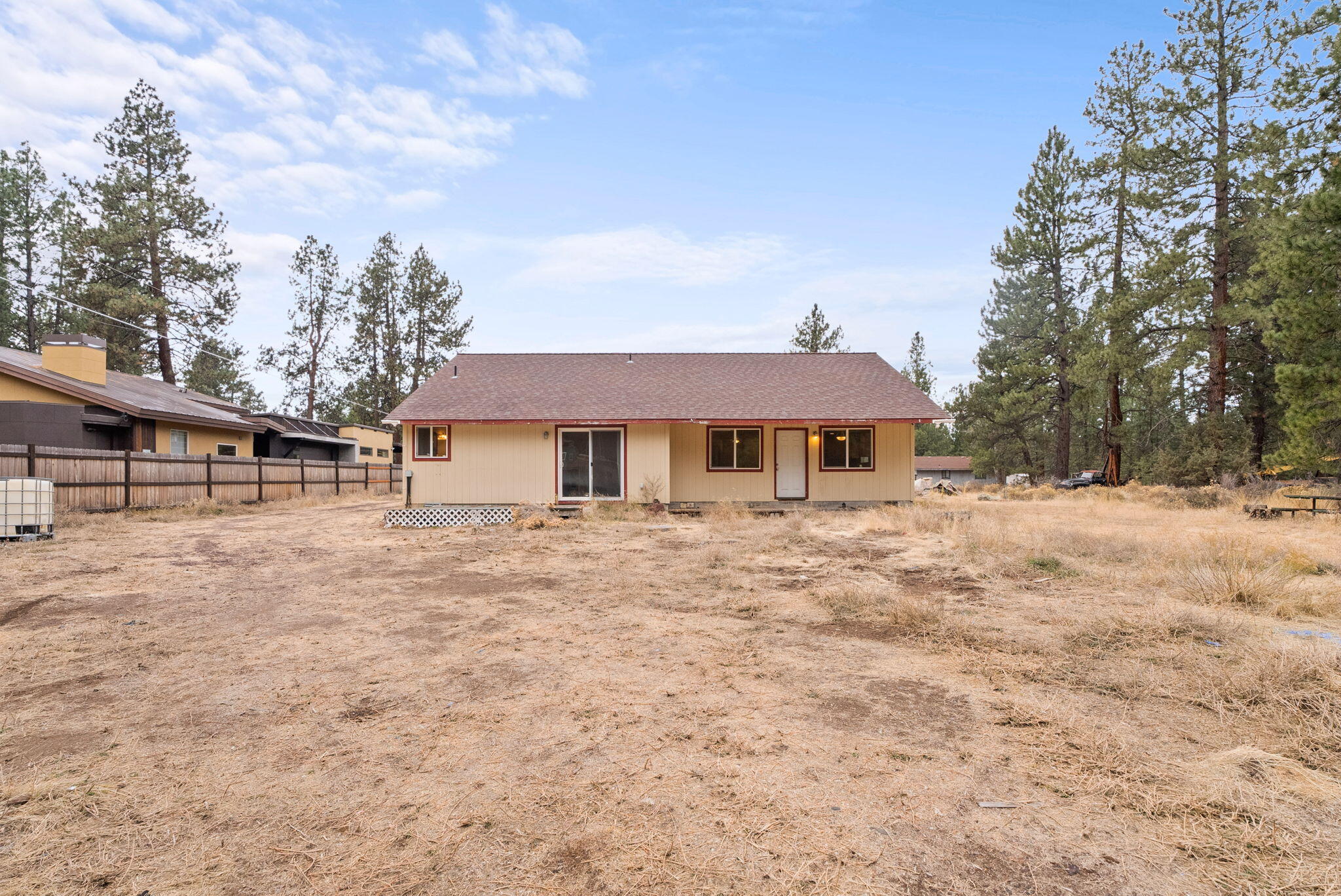 59674 Navajo Road Bend, OR 97702 - Photo 4 of 47 Back view of home. Kitchen at the back right corner of the photo. Primary bedroom at the back left corner of the photo.