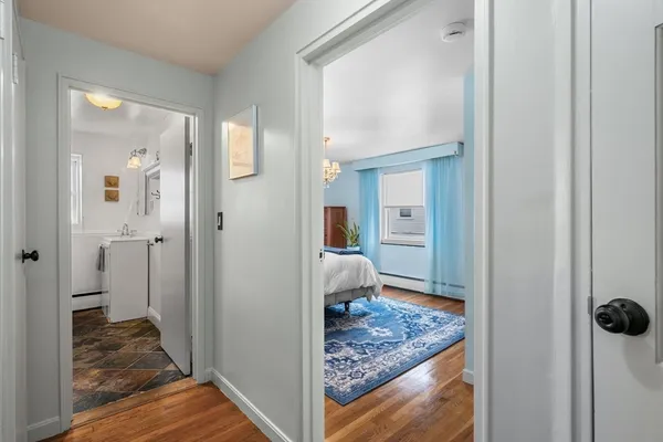 a view of a hallway with a livingroom and couch