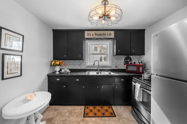 a kitchen with a refrigerator and a sink