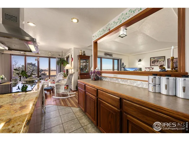 a living room with lots of furniture and view of kitchen