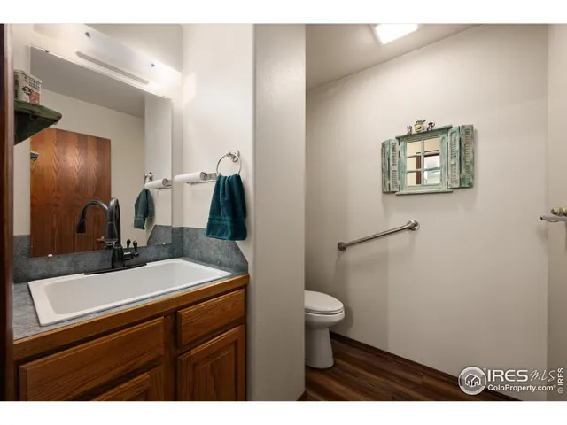 a bathroom with a sink a toilet and mirror