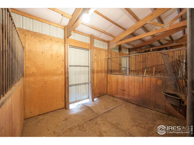 a bedroom with furniture and a large window