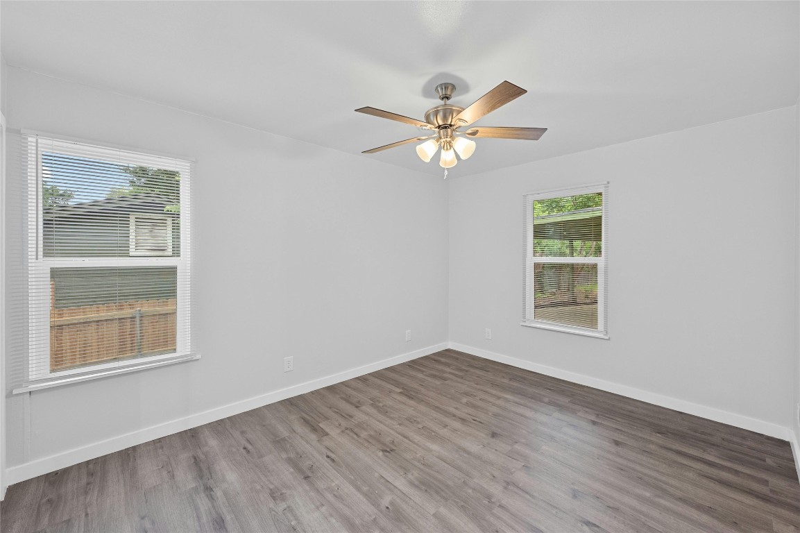 4906 Sylvandale Drive Austin, TX 78745 - Photo 13 of 28 a view of an empty room with a window and wooden floor