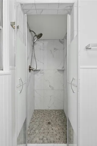 a bathroom with a glass shower door