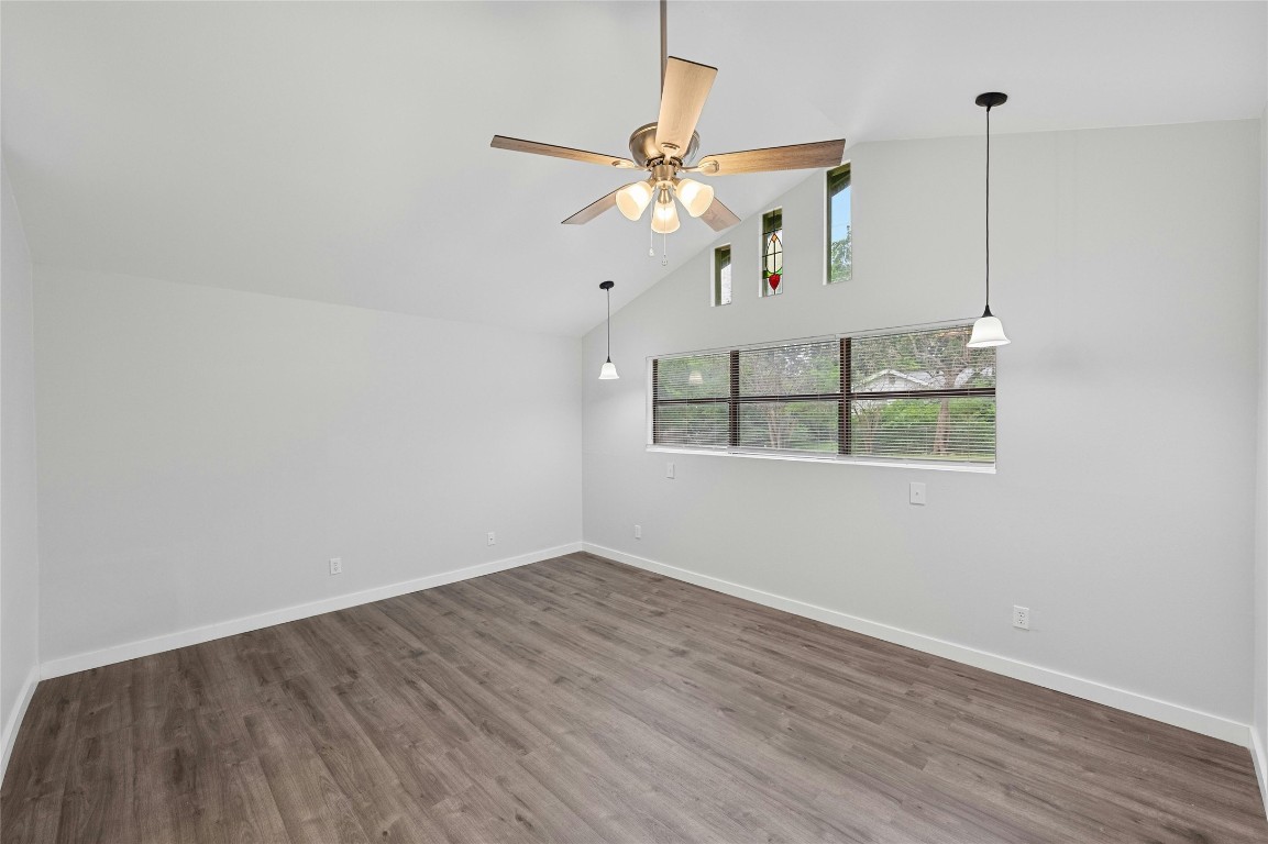 4906 Sylvandale Drive Austin, TX 78745 - Photo 17 of 28 a view of an empty room with wooden floor and a ceiling fan
