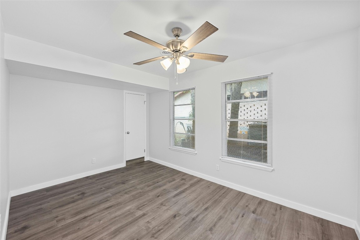 4906 Sylvandale Drive Austin, TX 78745 - Photo 20 of 28 a view of an empty room with wooden floor and a window