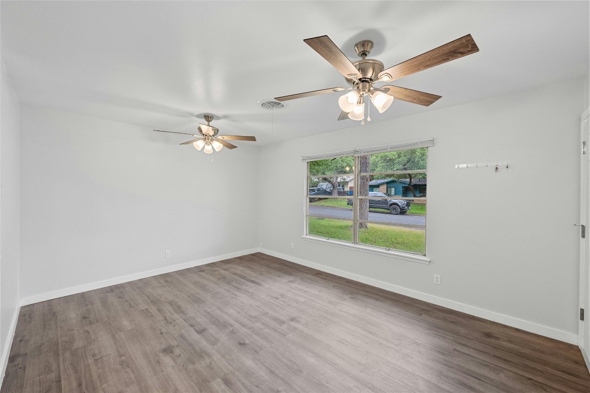 4906 Sylvandale Drive Austin, TX 78745 - Photo 6 of 28 an empty room with windows and fan