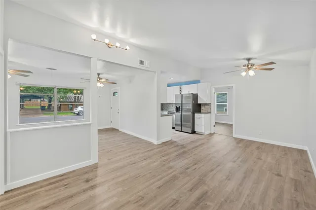 a view of a kitchen with a sink cabinet a kitchen and an entryway